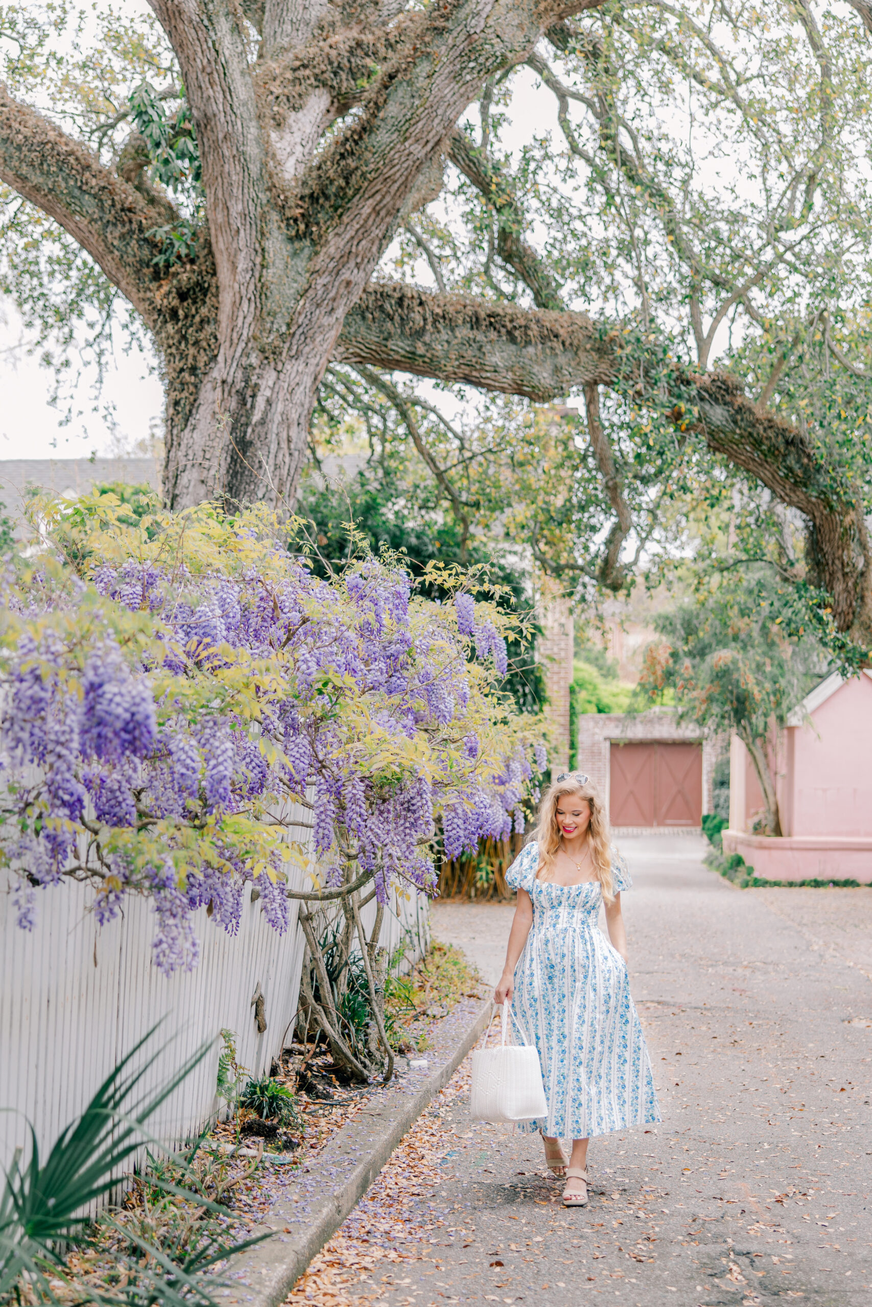 girl wearing summer blue dress walking in aesthetic downtown charleston